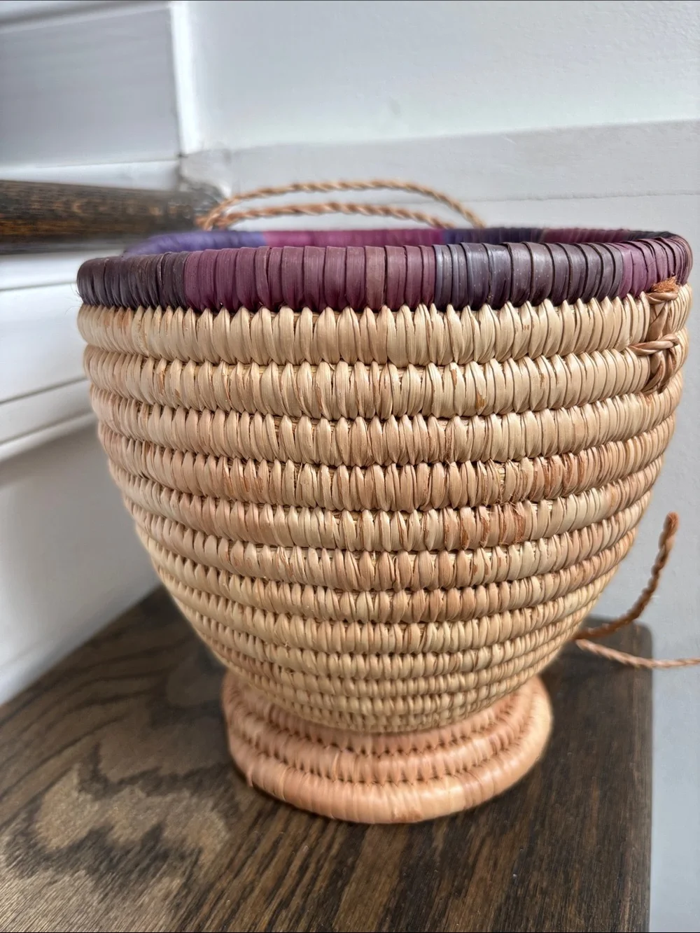 Woven palm leaves? footed basket, purple stripe on rim, 7.5” tall